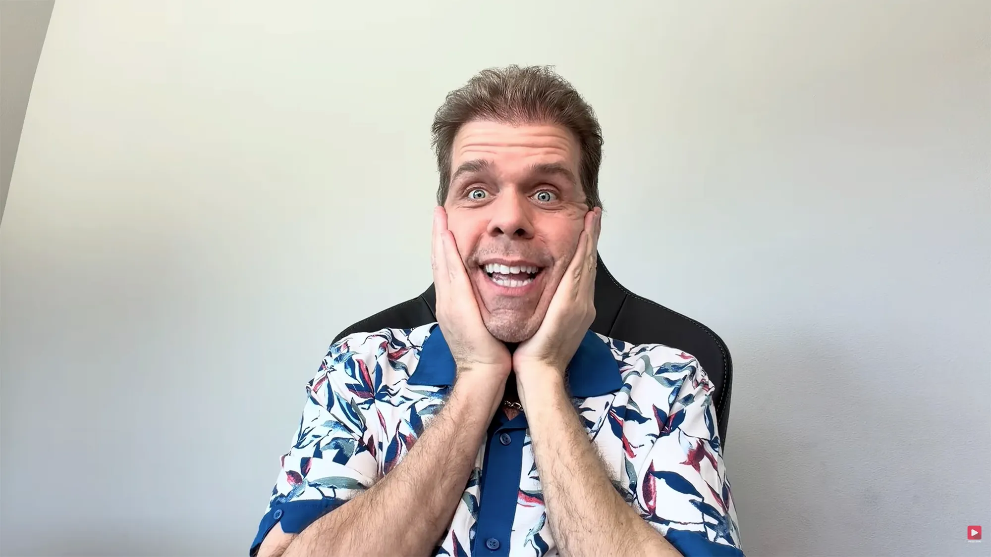 Perez Hilton with hands on his cheeks and a surprised expression.