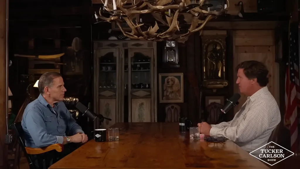 Tucker Carlson interviews a guest on his show.