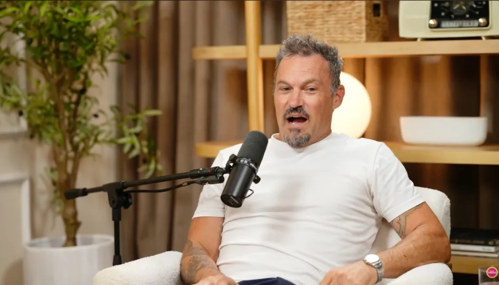 Brian Austin Green speaking into a microphone.
