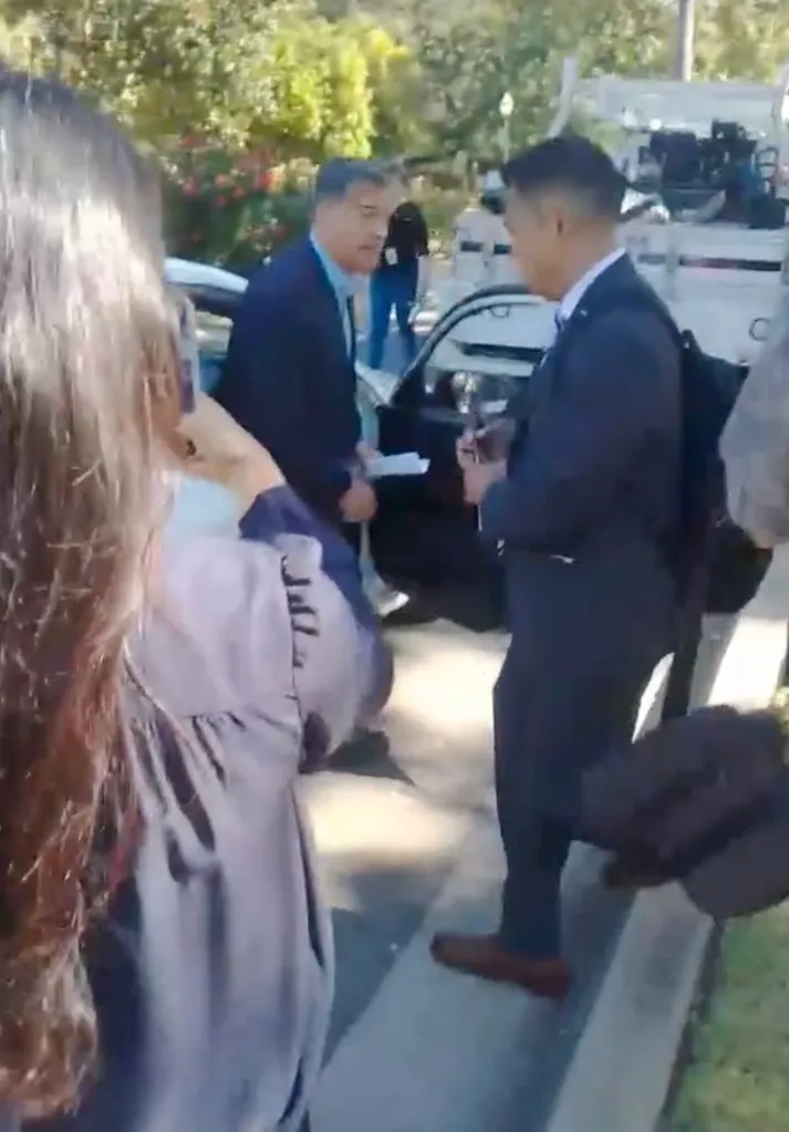 Xavier Becerra surrounded by individuals, refusing to answer questions about the migrant child crisis.