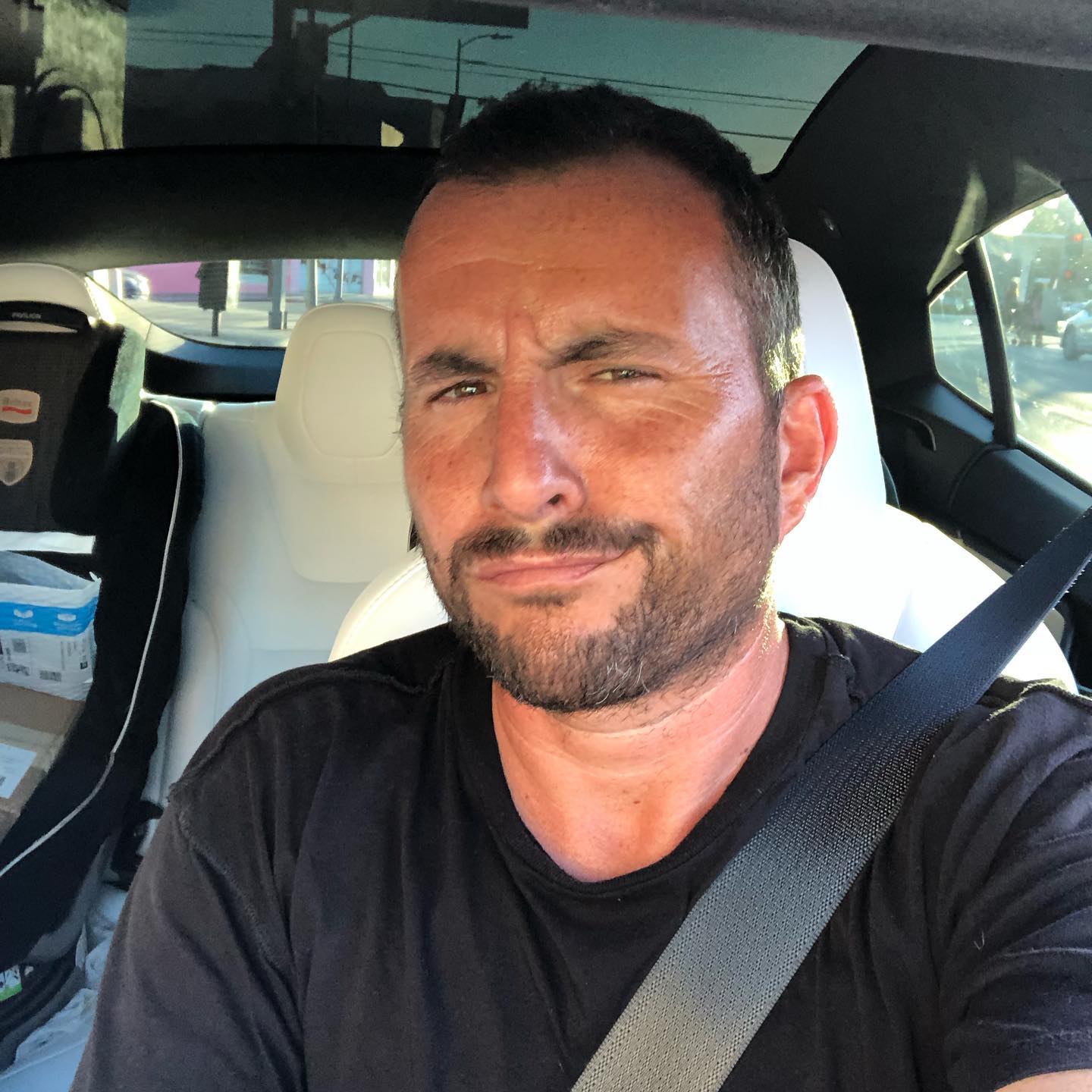 Zach Goldsmith taking a selfie in a car.