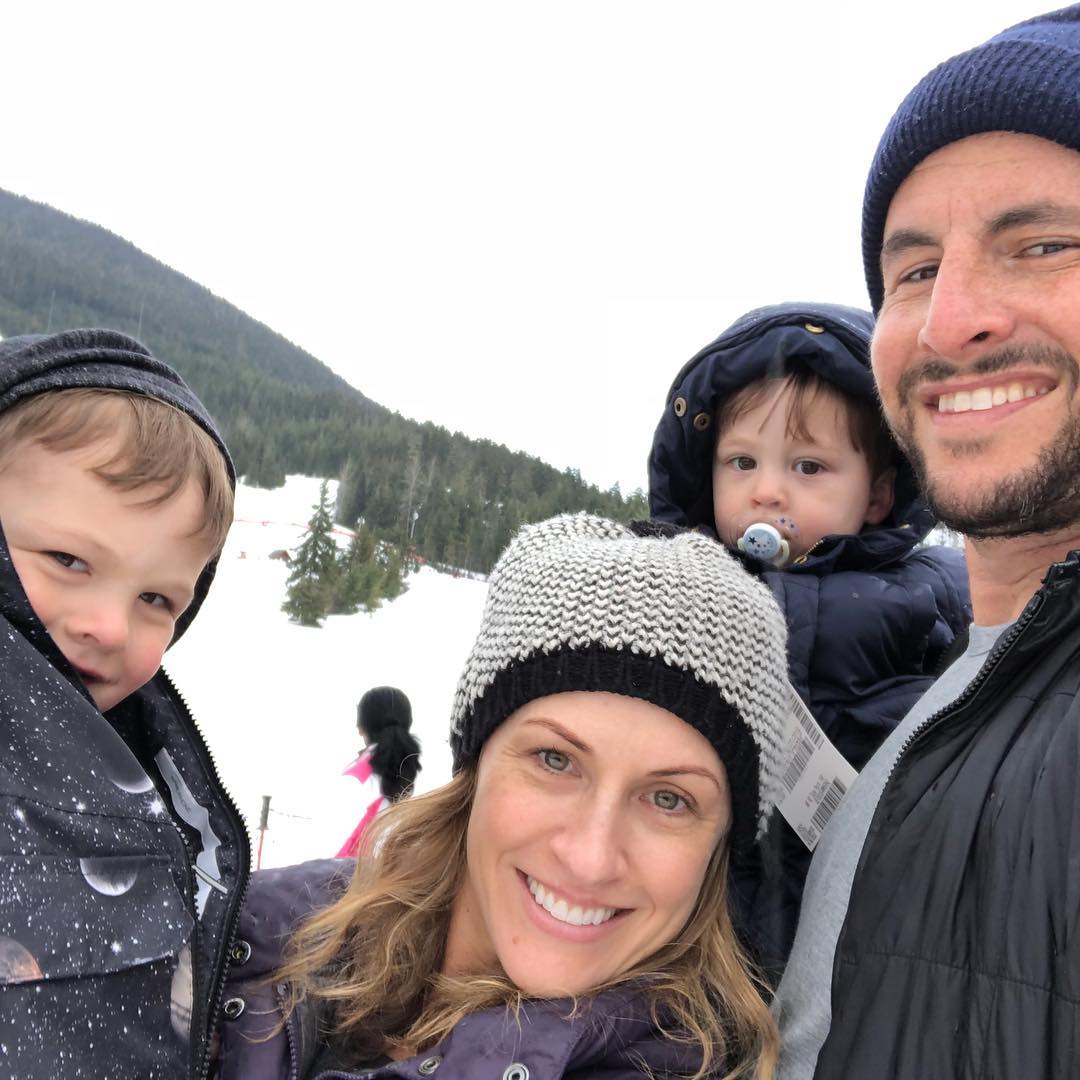 Zach Goldsmith, his ex-wife, and two children on a snowy mountainside.