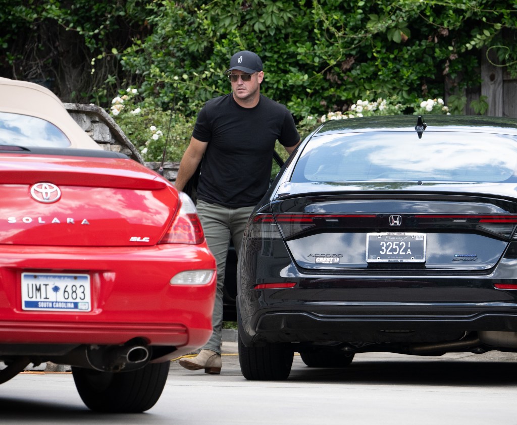 Zach Hickerson exiting a black Honda Accord car in Greenville, South Carolina.