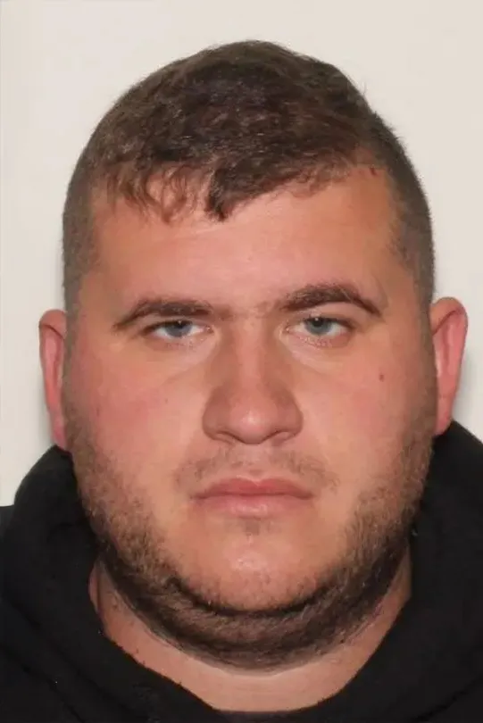 Mugshot of Skylar Thompson, a man with short brown hair, stubble, and blue eyes.