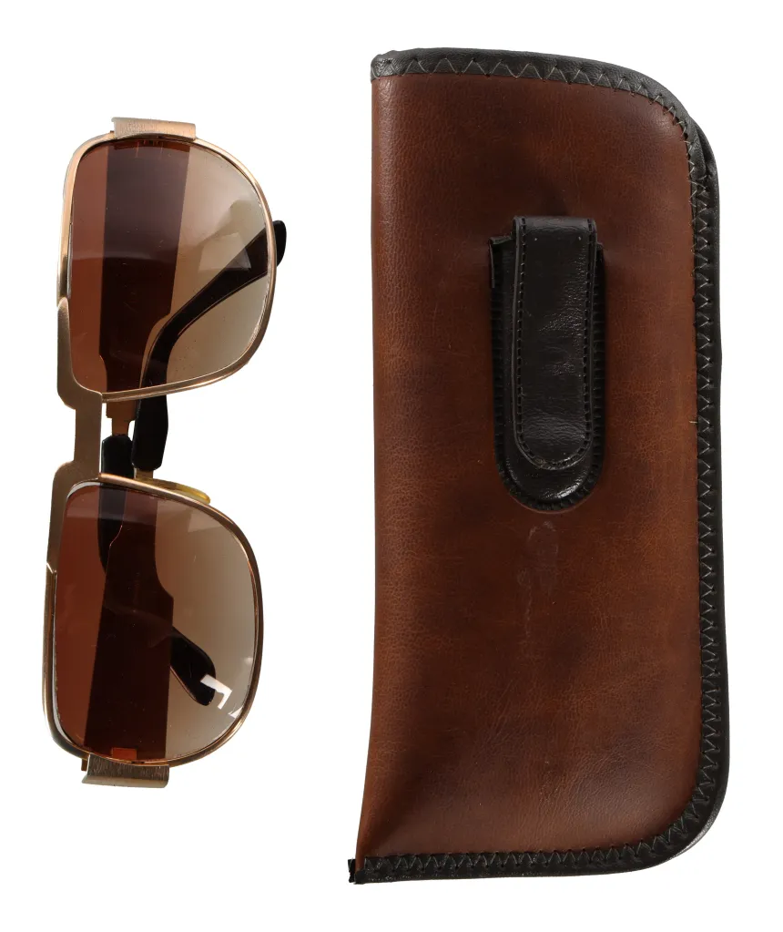Elvis Presley's Neostyle Nautic 2 sunglasses alongside their brown leather case.