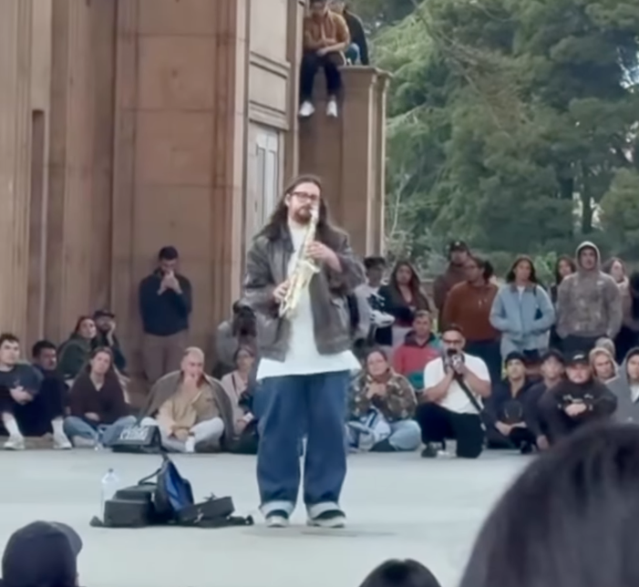 Nathaniel Young playing saxophone to a large crowd at San Francisco's Palace of Fine Arts.