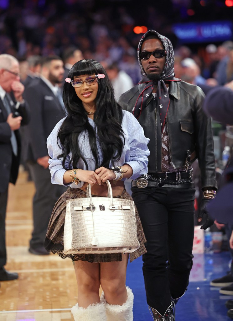 Cardi B and Offset walk off the court during Game 5 of the NBA playoffs.