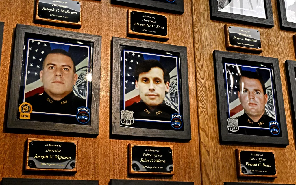 Memorial wall featuring photographs and plaques for deceased police officers.