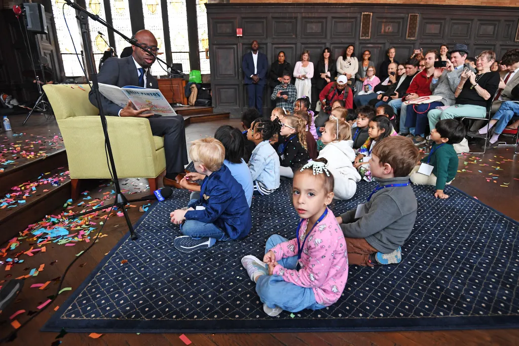 Public Schools Chancellor Kamar Samuels reads Parton's book, 