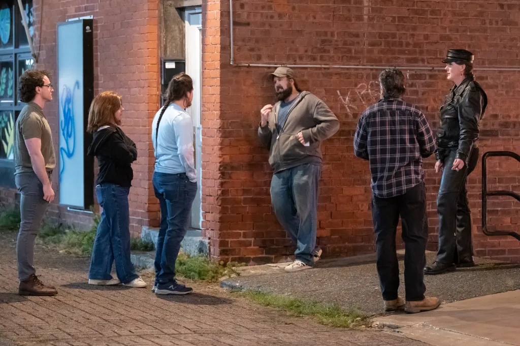 Staff and patrons stand outside the entrance of the Last Ditch Lesbian Bar, Sept. 26, 2026, in Greenfield, Mass.