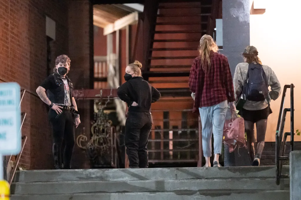 Two staffers and others stand outside the entrance of the Last Ditch Lesbian Bar in Greenfield, Mass. on Sept. 26, 2026.