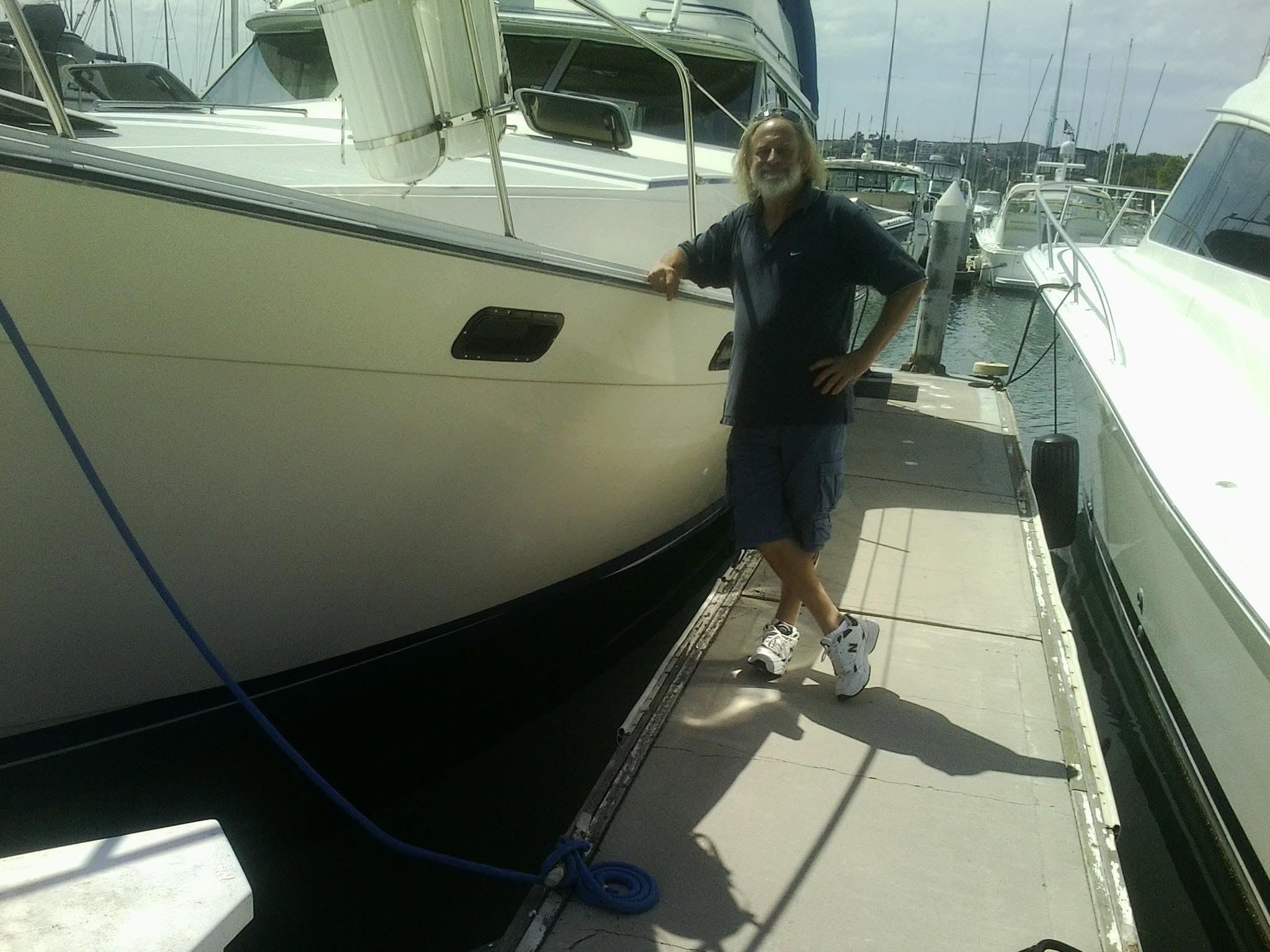 Christopher Nicks standing on a dock next to a boat.
