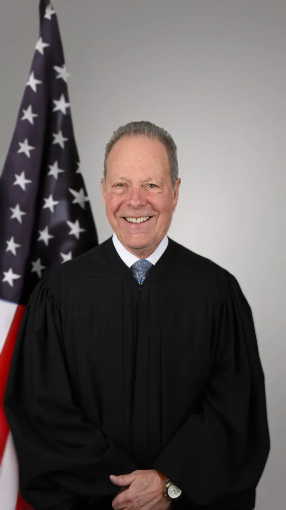 Westchester County Court Judge George Fufidio smiles while wearing a judicial robe.