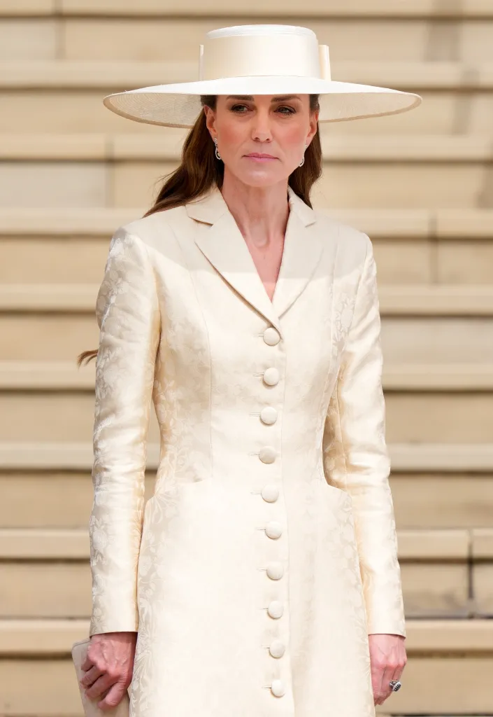 Catherine, Princess of Wales, in a cream-colored outfit and wide-brimmed hat.