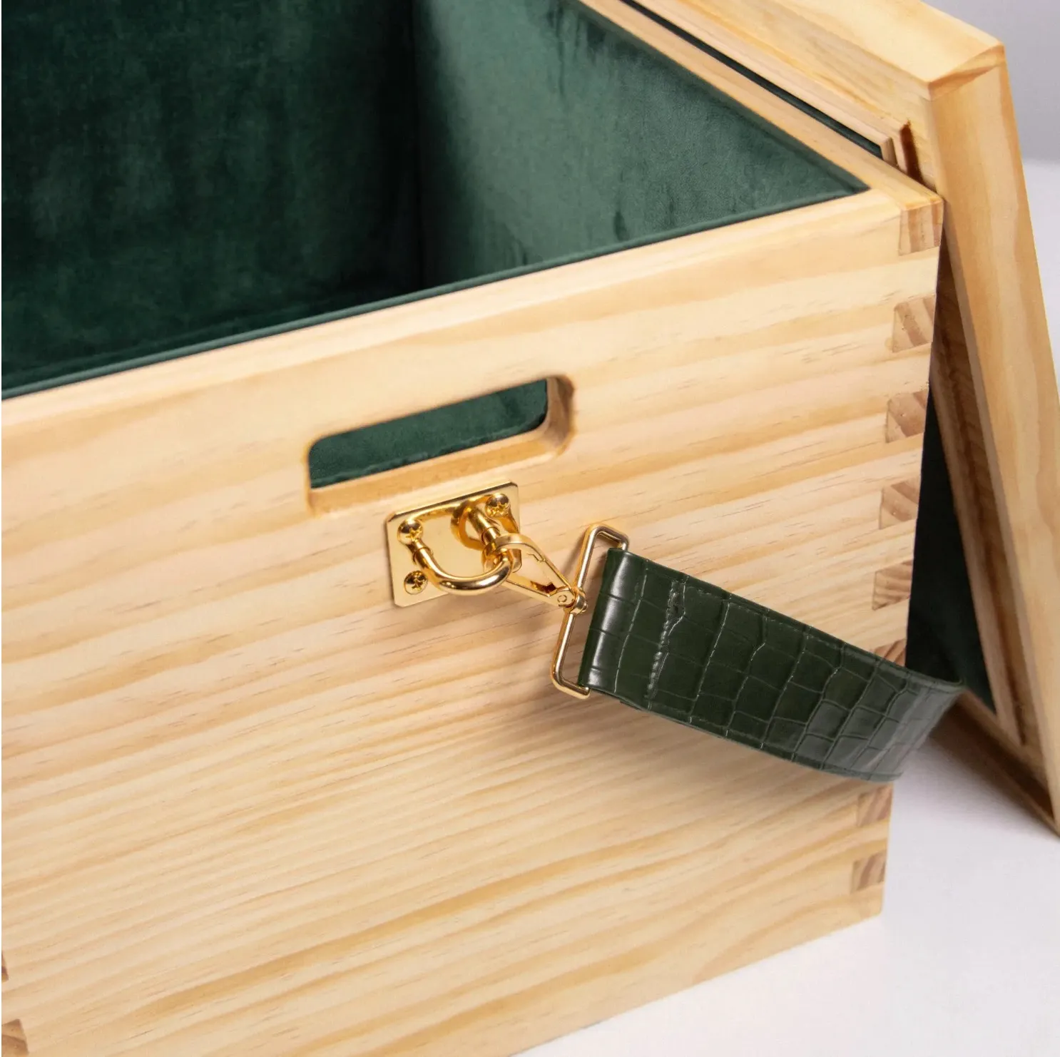 Wooden box with dark green velvet interior and a faux crocodile skin strap.