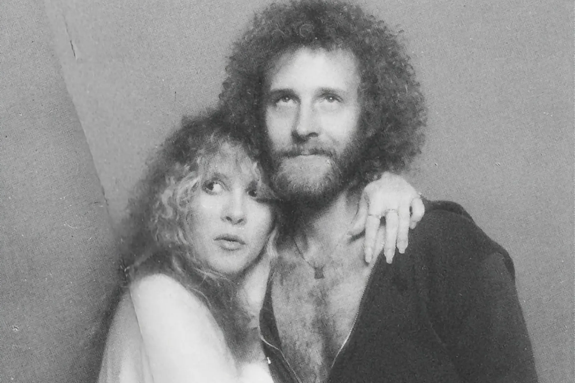 Stevie Nicks with Lindsey Buckingham, her arm around his shoulder.
