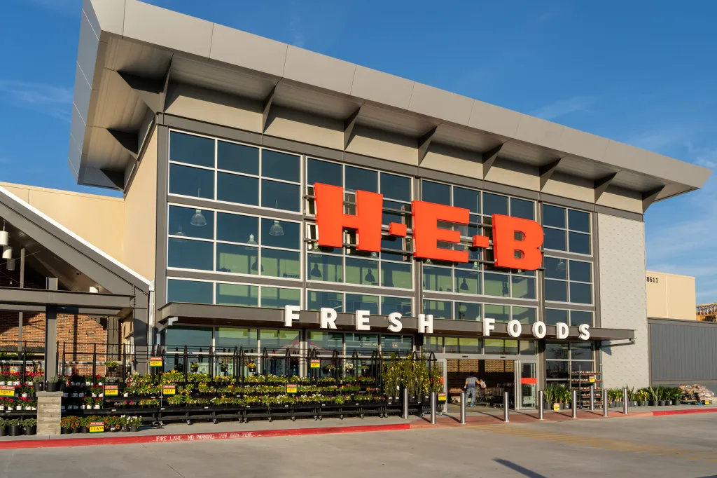 Exterior of an H-E-B supermarket with the large red 
