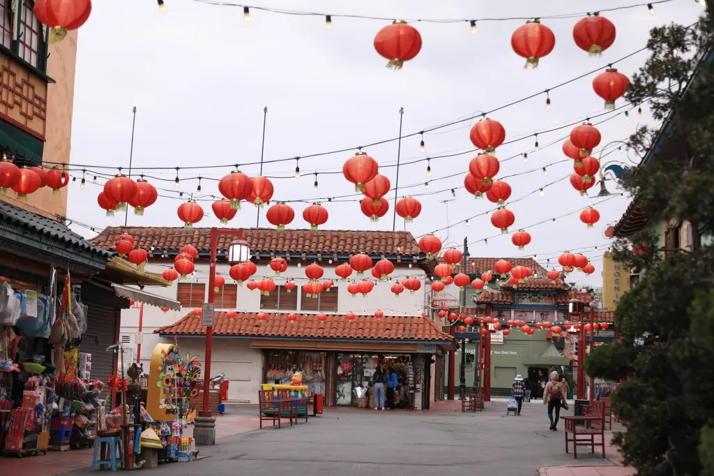 Red Chinese lanterns hang over a street in Chinatown, Los Angeles.