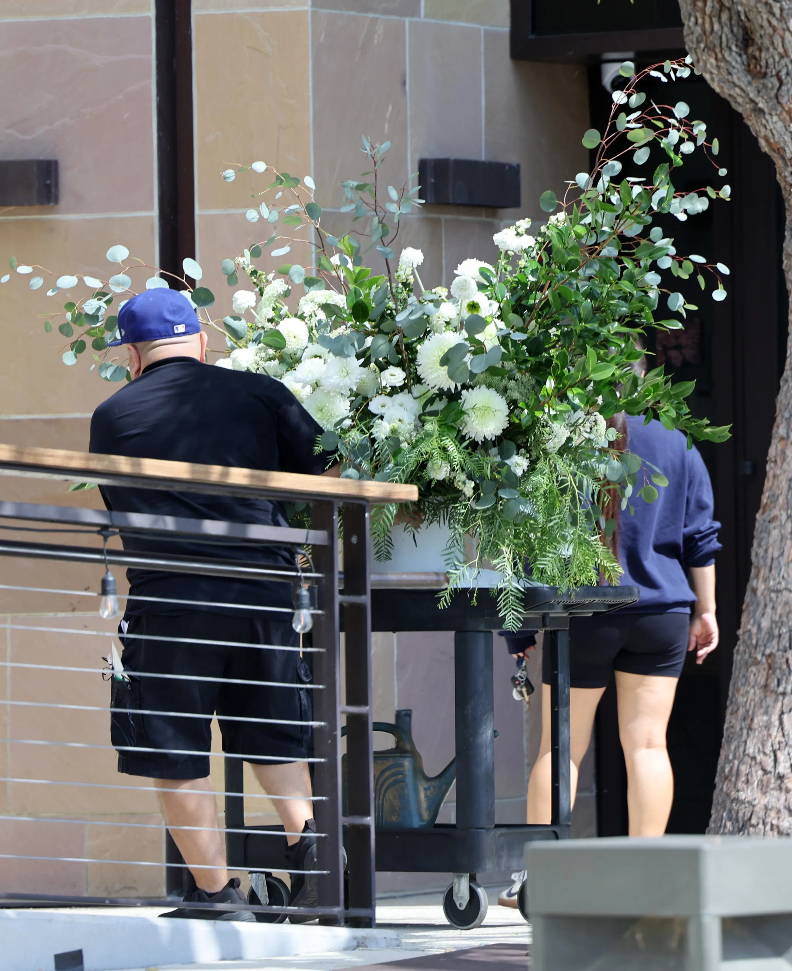 People transporting flowers at Malibu Pacific Church for Hayden Panettiere's celebration of life.