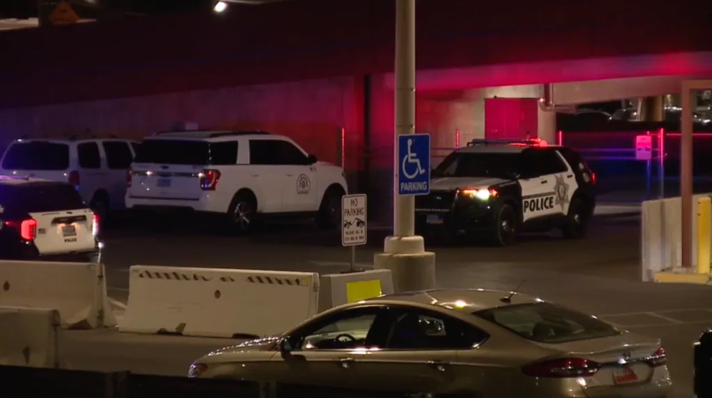 Police vehicles with flashing lights at Harry Reid International Airport.