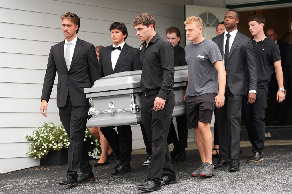 Pallbearers carry the casket of Glenwood