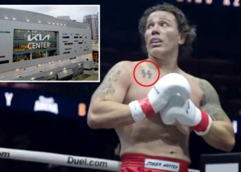 Kickboxer with SS tattoo gives Nazi salute after beating Jewish opponent — as supporters hold swastika banner