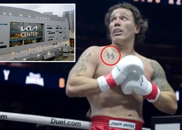 Kickboxer with SS tattoo gives Nazi salute after beating Jewish opponent — as supporters hold swastika banner