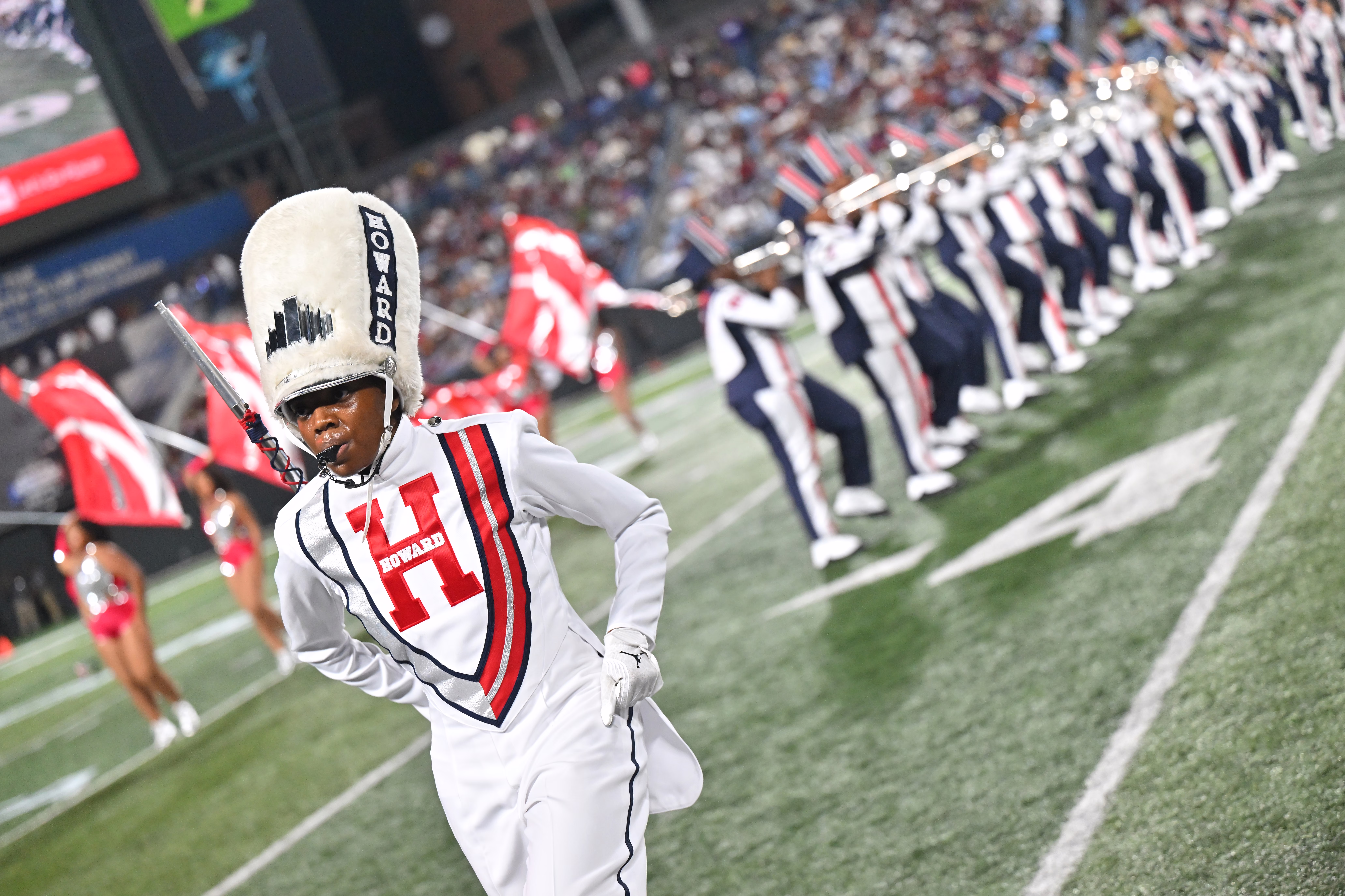 Members of a marching band perform during halftime at a football game.