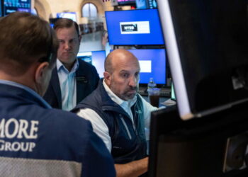 Stocks fall after a surprisingly strong jobs report raises prospects of an interest rate hike