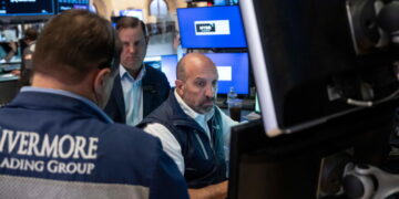 Stocks fall after a surprisingly strong jobs report raises prospects of an interest rate hike