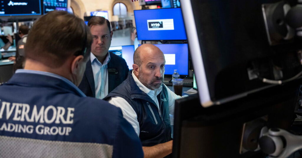 Stocks fall after a surprisingly strong jobs report raises prospects of an interest rate hike