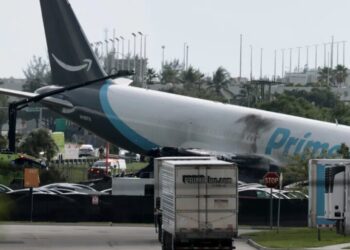 Amazon cargo plane barrels off runway, crashing into multiple vehicles and forcing Miami International Airport to ground all flights