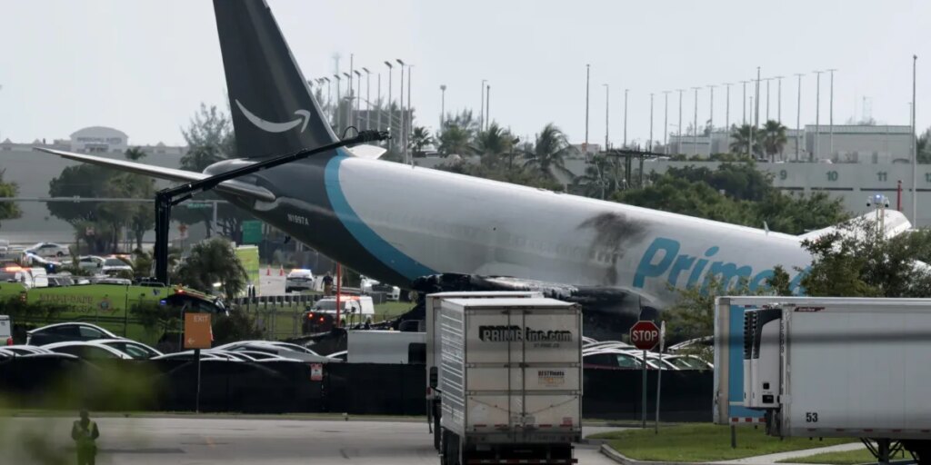 Amazon cargo plane barrels off runway, crashing into multiple vehicles and forcing Miami International Airport to ground all flights
