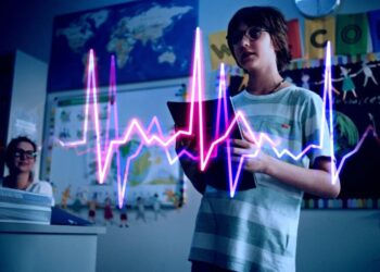 AI School Hooking Children Up to Heart Monitor in Front of Class While Playing Critiques of Their Work