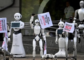 Dozens of Humanoid Robots Gather for a Protest, Marching and Waving Signs