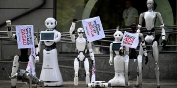 Dozens of Humanoid Robots Gather for a Protest, Marching and Waving Signs