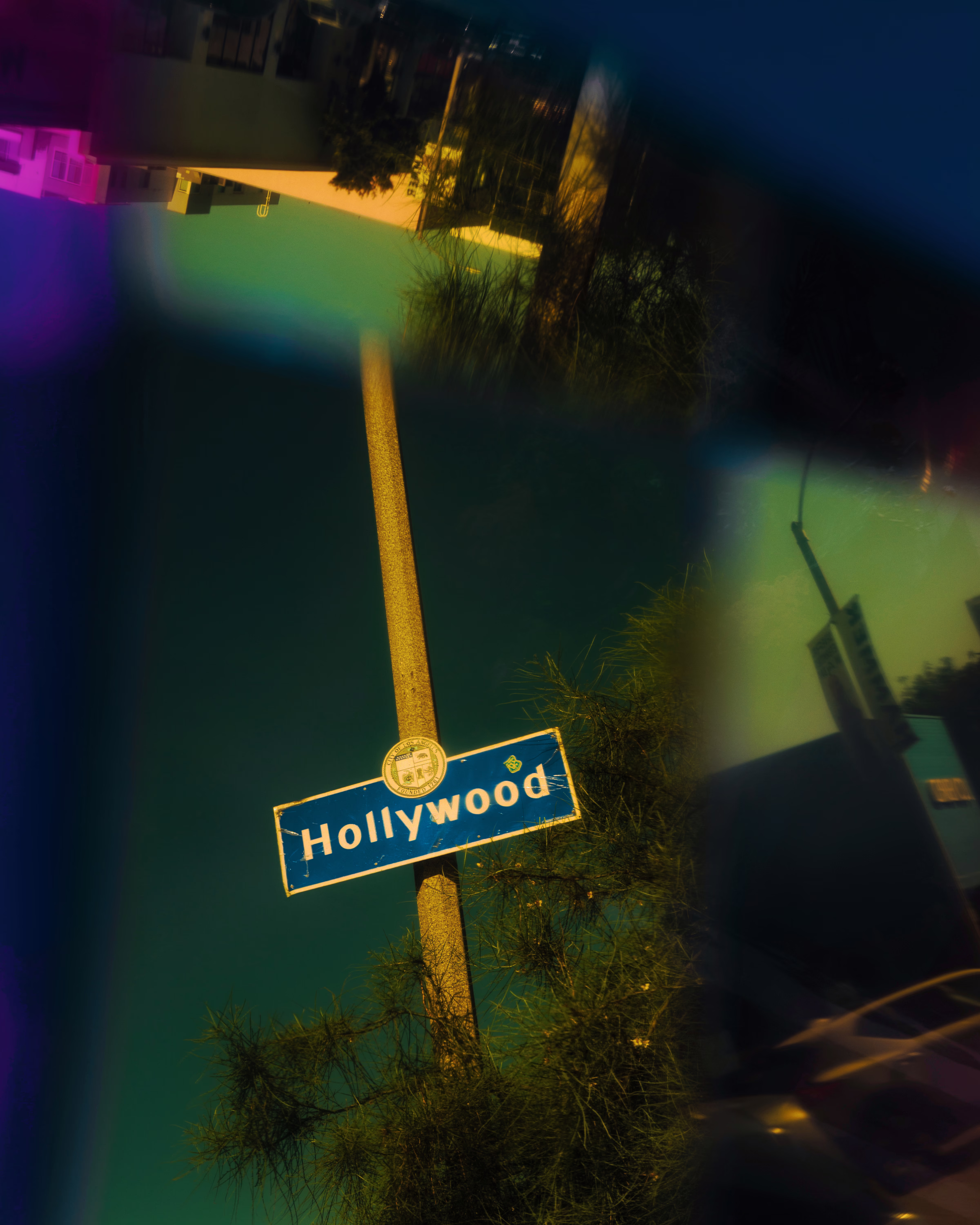 photo of streetlamp post with 'Hollywood' sign 