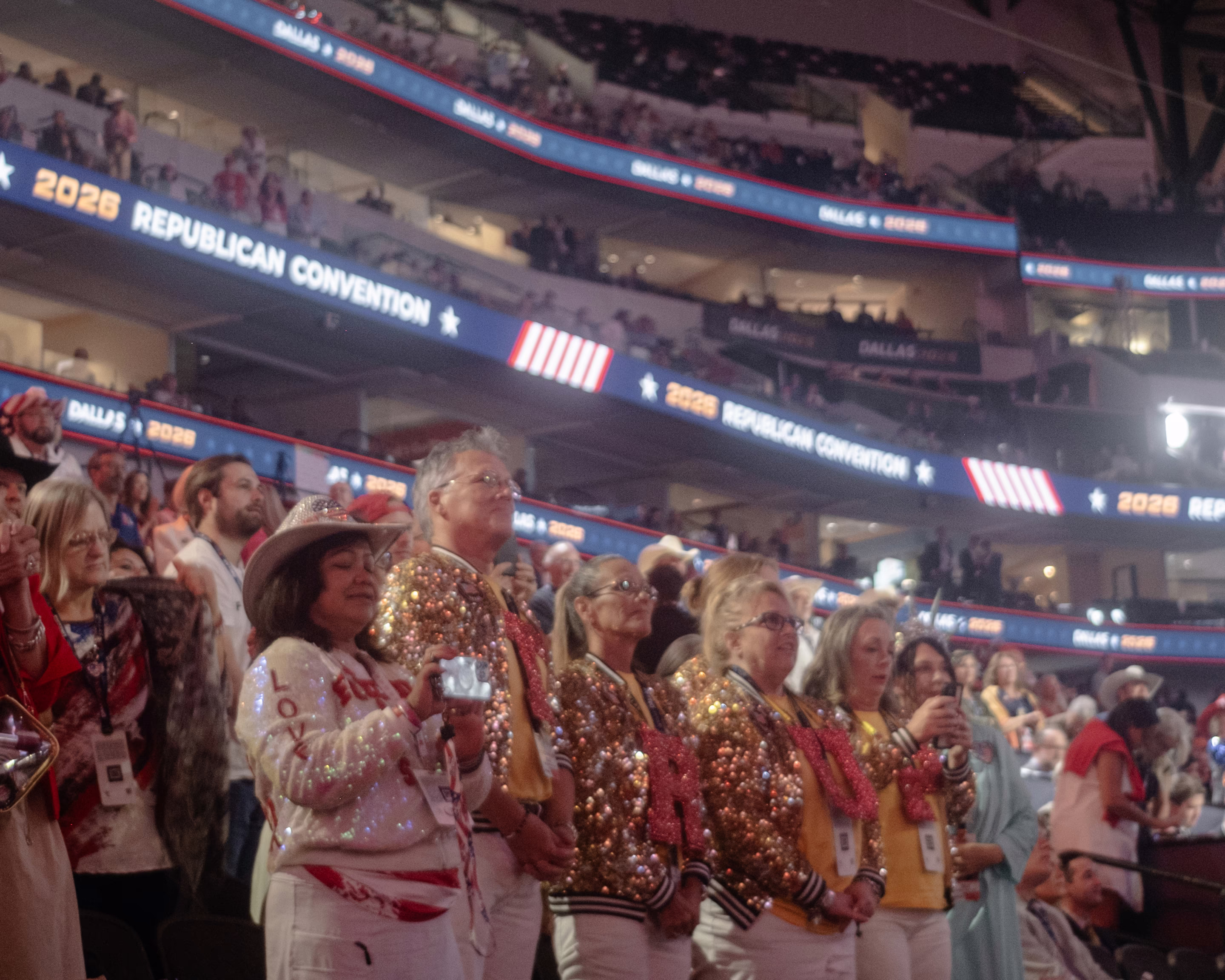people stand at an arena