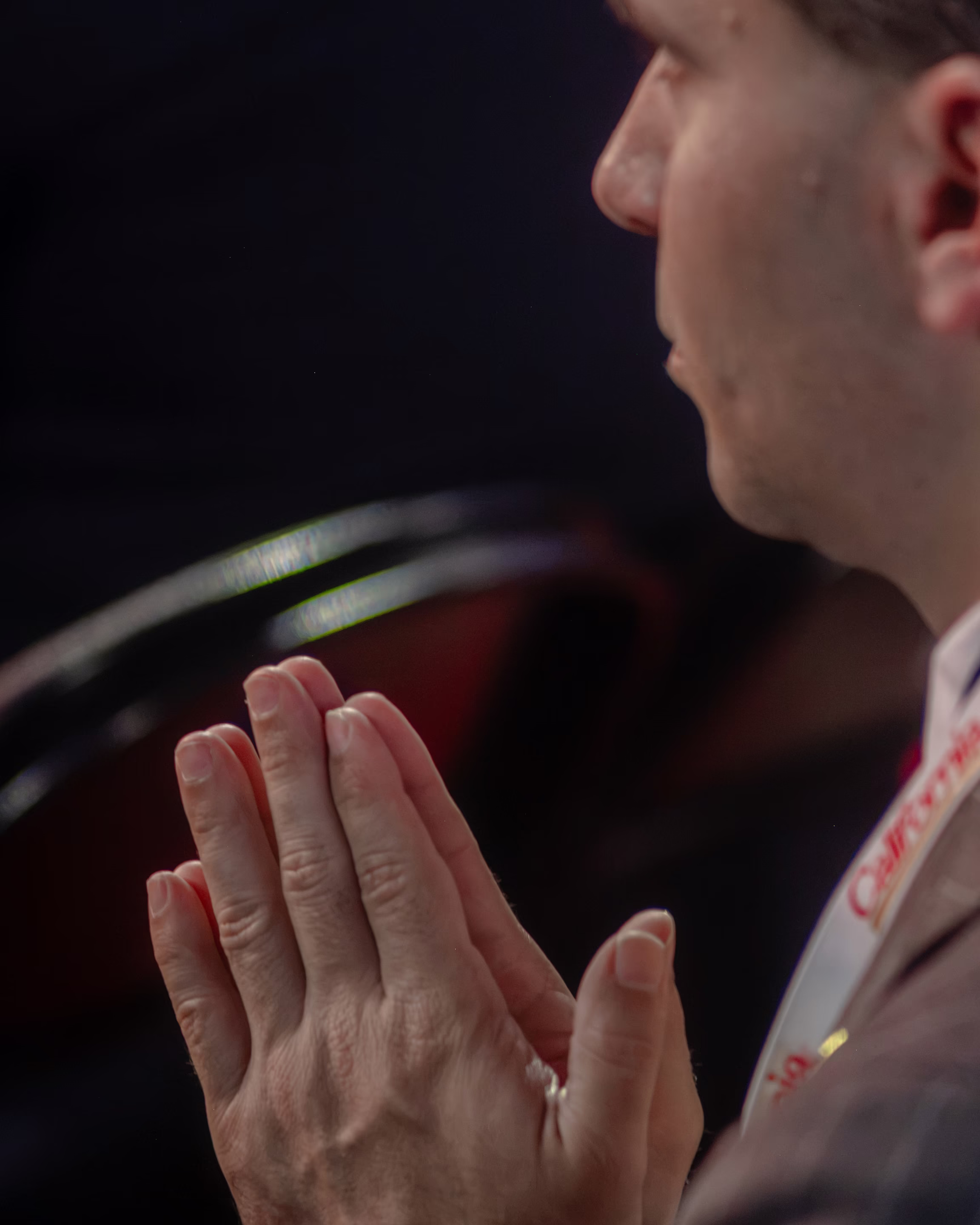 a man holds his hands in prayer