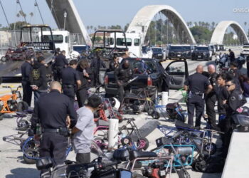Scores of minibike riders penned in and arrested on 6th Street Bridge. They lost their bikes too