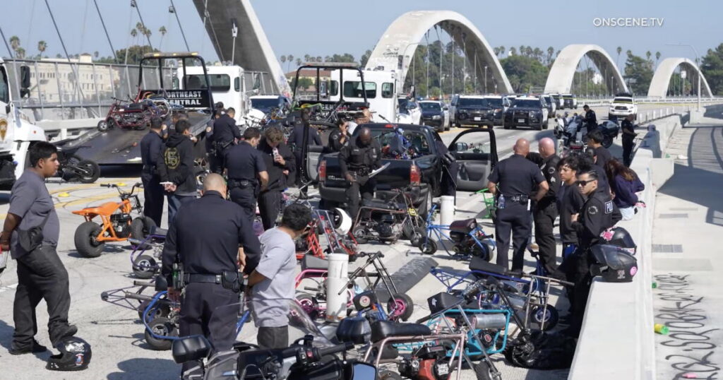 Scores of minibike riders penned in and arrested on 6th Street Bridge. They lost their bikes too