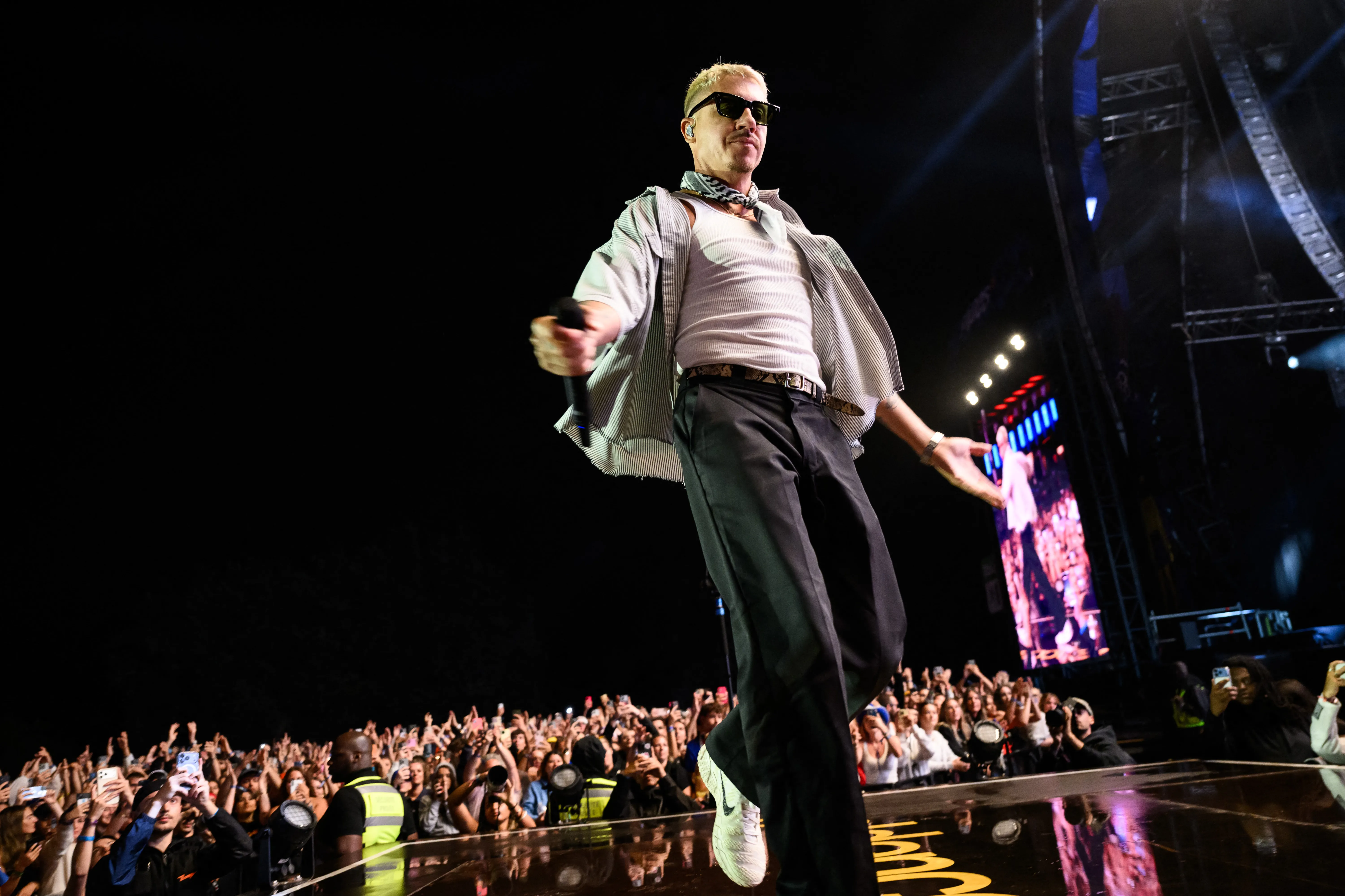 Macklemore performing on stage at the Goldencoast Rap Festival.