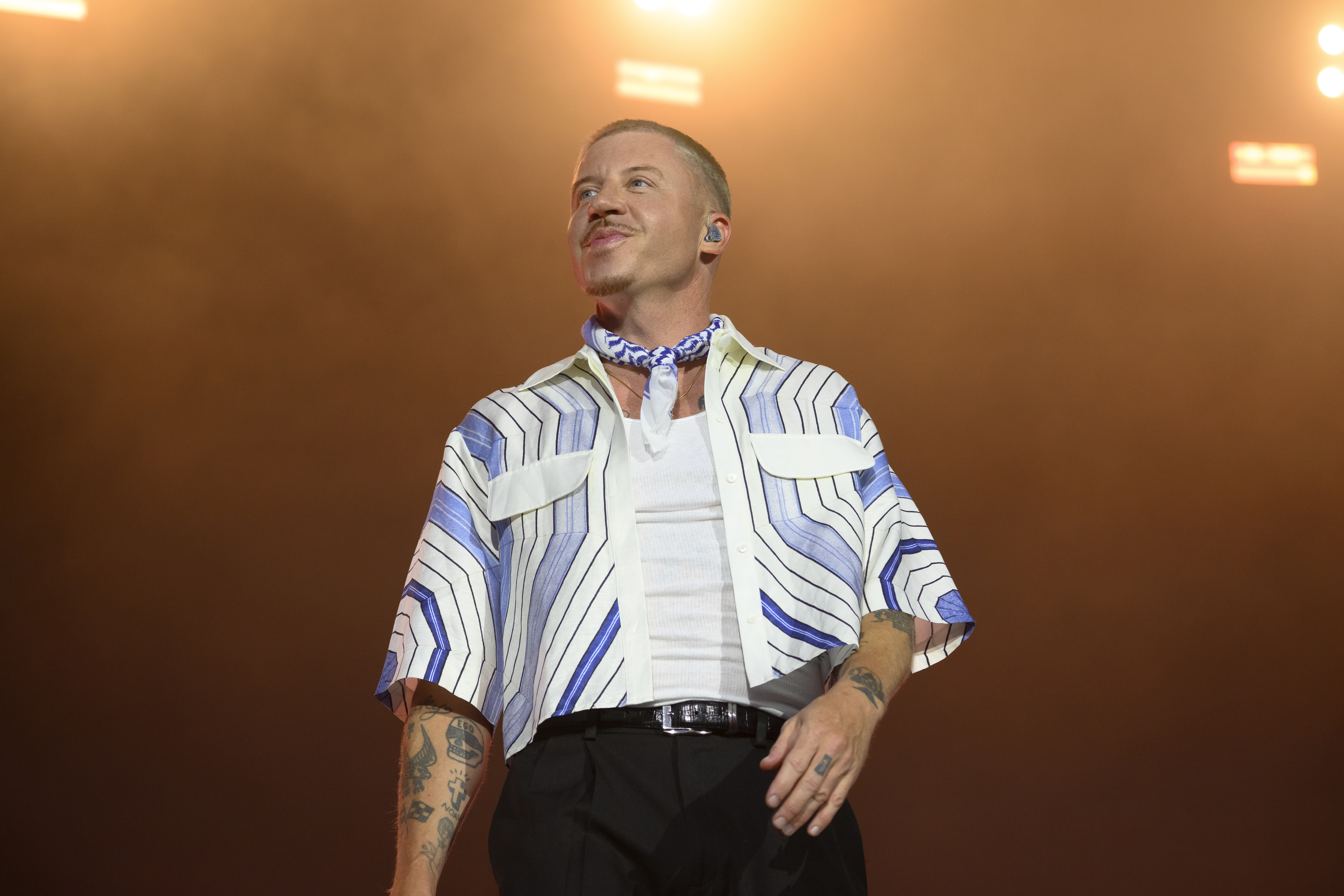American rapper Macklemore performing live on stage.