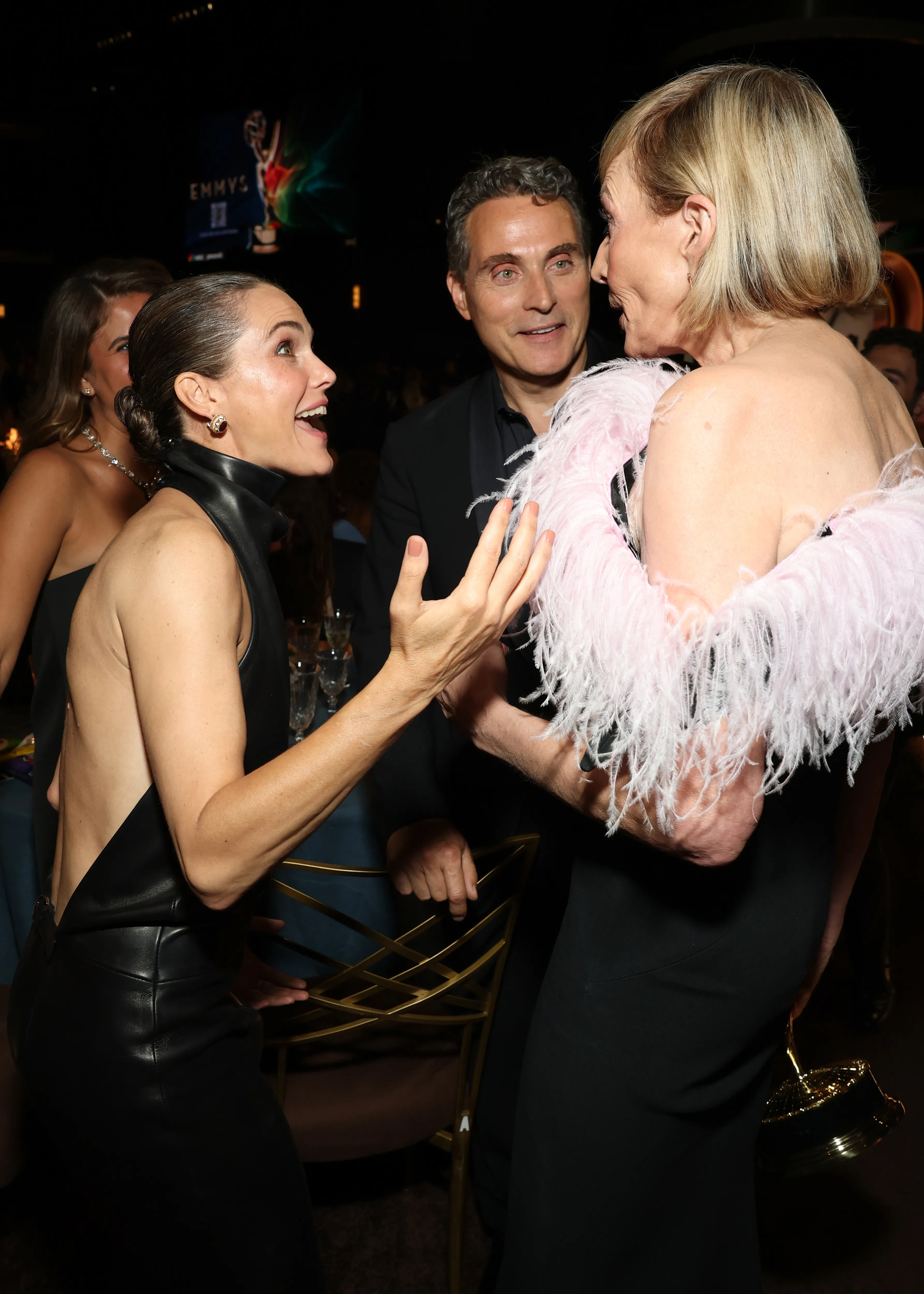 Keri Russell and Allison Janney speaking with Rufus Sewell in the background at the 78th Primetime Emmy Awards.