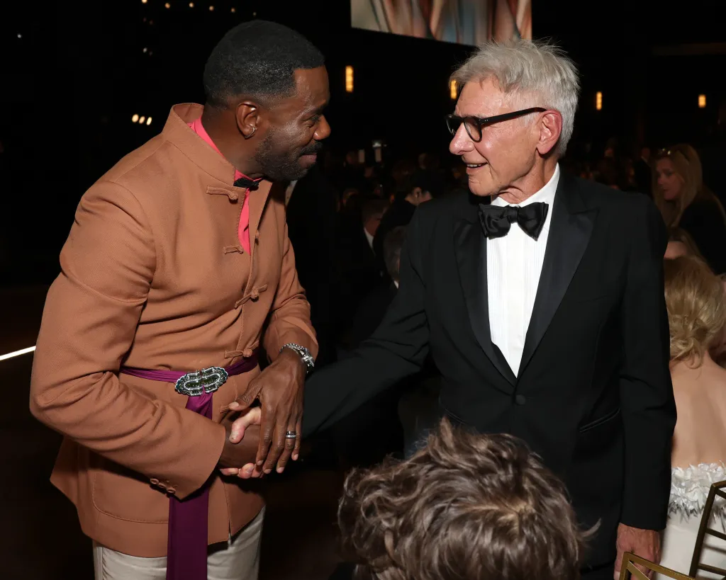 Colman Domingo and Harrison Ford shake hands and smile at the 78th Primetime Emmy Awards.