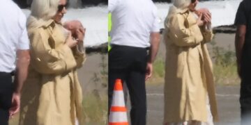Glam Lady Gaga cradles her baby as she touches down in LA with fiancé Michael Polansky