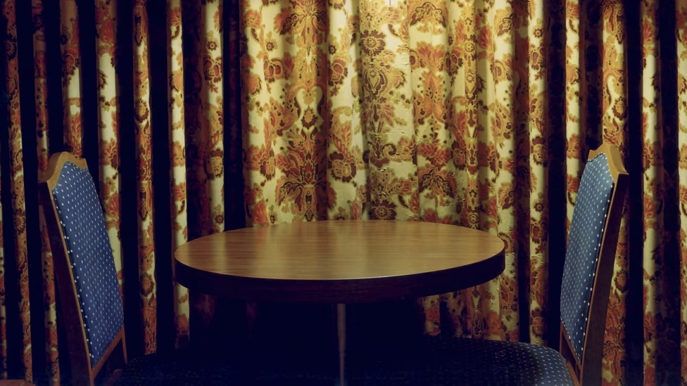 two empty chairs on opposite sides of a round table