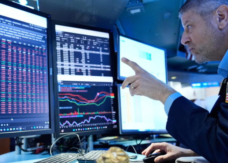 Stocks slip after the Fed hikes interest rates and hints more increases may be on the way