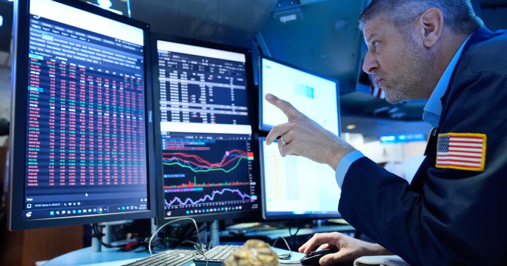 Stocks slip after the Fed hikes interest rates and hints more increases may be on the way