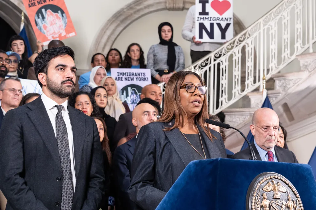 Attorney General Letitia James speaks at a podium alongside Mayor Zohran Mamdani and other advocates.